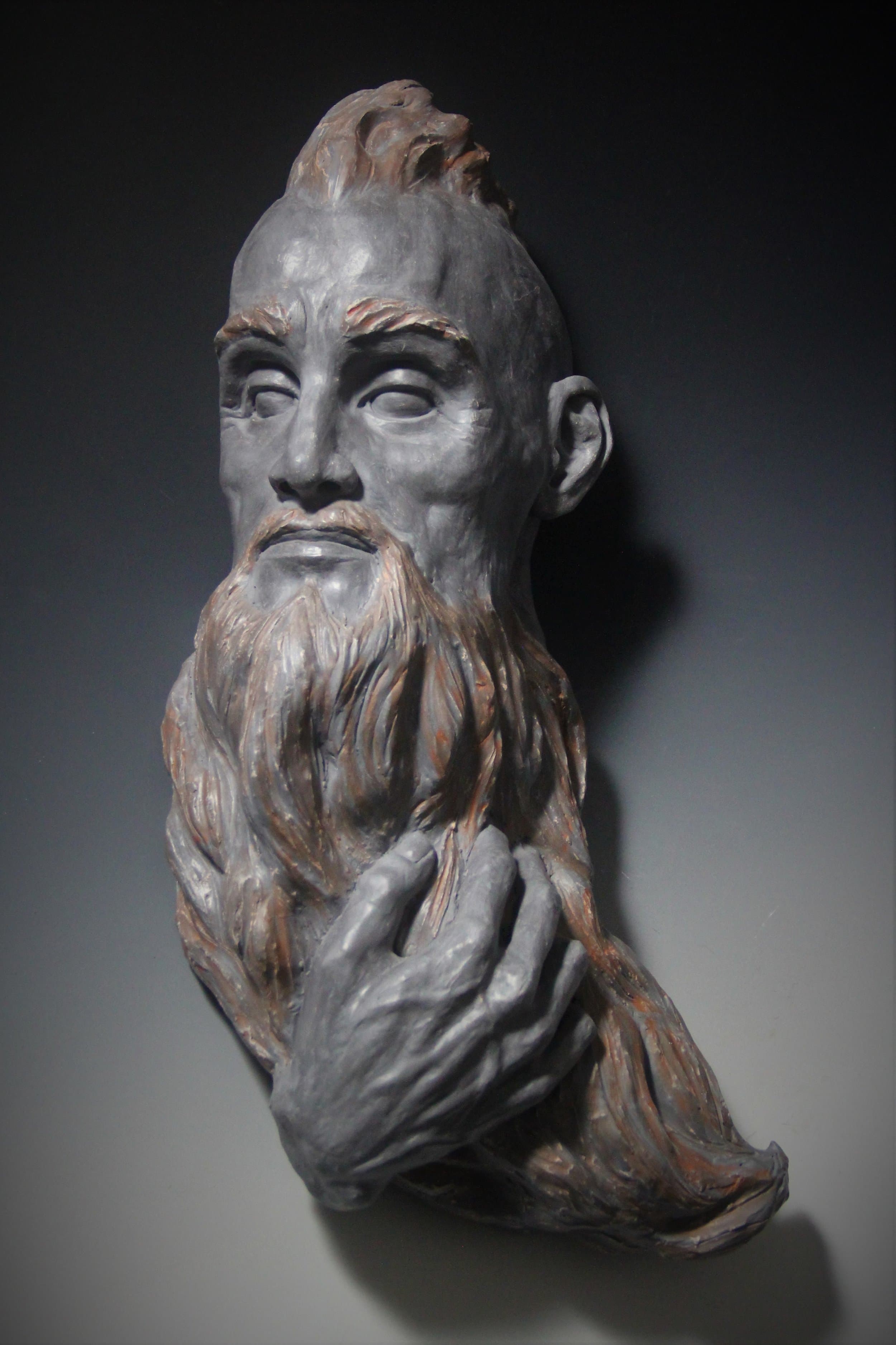 A sculpture of a warrior figure, the artwork featured on the Warrior release